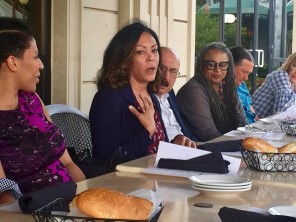 Dr. Josey LaKeetra speaking to a group around a table